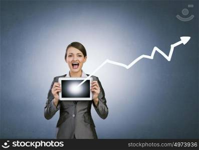Woman with tablet. Beautiful young woman holding tablet pc with graph against her chest