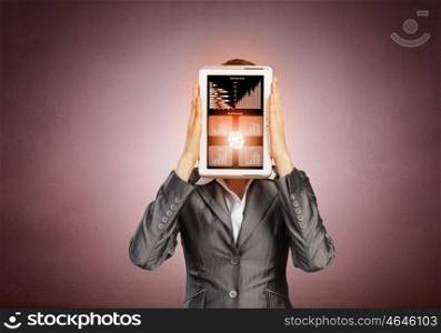 Woman with tablet. Beautiful young woman holding tablet pc with graphs against her face