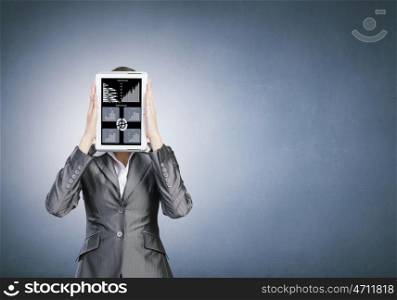 Woman with tablet. Beautiful young woman holding tablet pc with graphs against her face