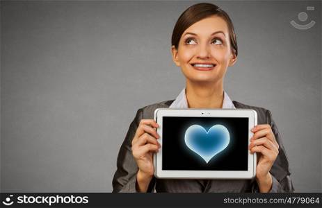 Woman with tablet. Beautiful young woman holding tablet pc with love heart