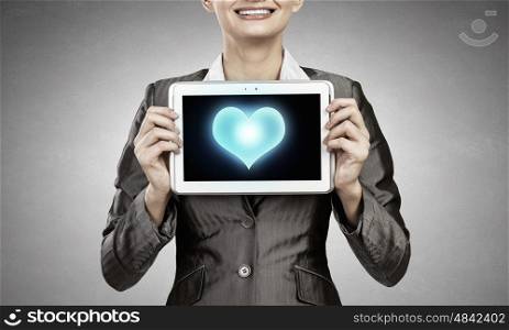 Woman with tablet. Beautiful young woman holding tablet pc with love heart