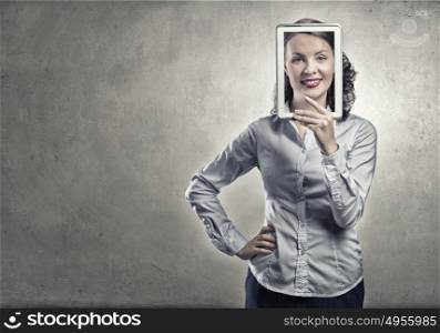 Woman with tablet expressing positivity. Smiling woman holding tablet instead of her face