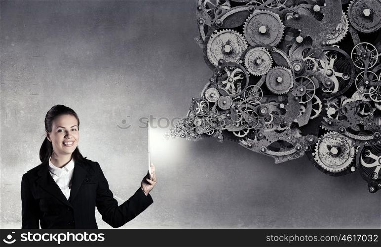 Woman with tablet pc. Young businesswoman holding tablet on dark background