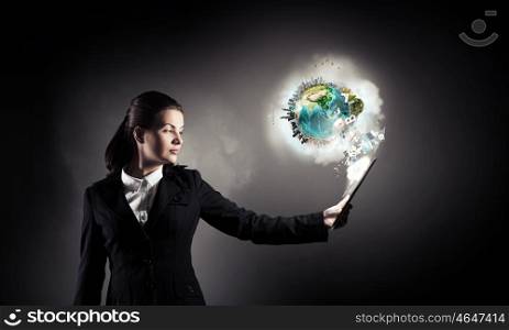 Woman with tablet pc. Young businesswoman holding tablet on dark background. Elements of this image are furnished by NASA