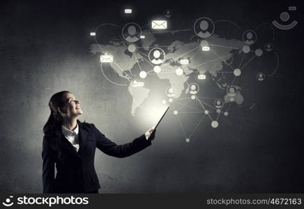 Woman with tablet pc. Young businesswoman holding tablet on dark background