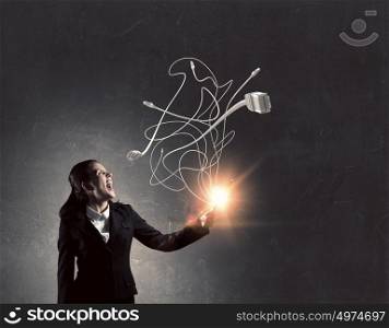 Woman with tablet pc. Young emotional businesswoman holding tablet on dark background