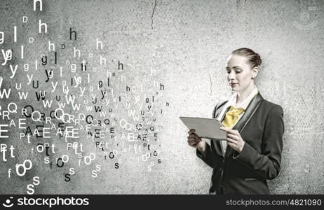 Woman with tablet pc. Young woman holding tablet pc in hands and letters flying around