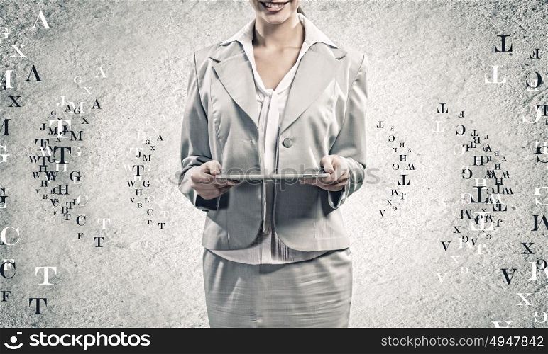 Woman with tablet pc. Young woman holding tablet pc in hands and letters flying around