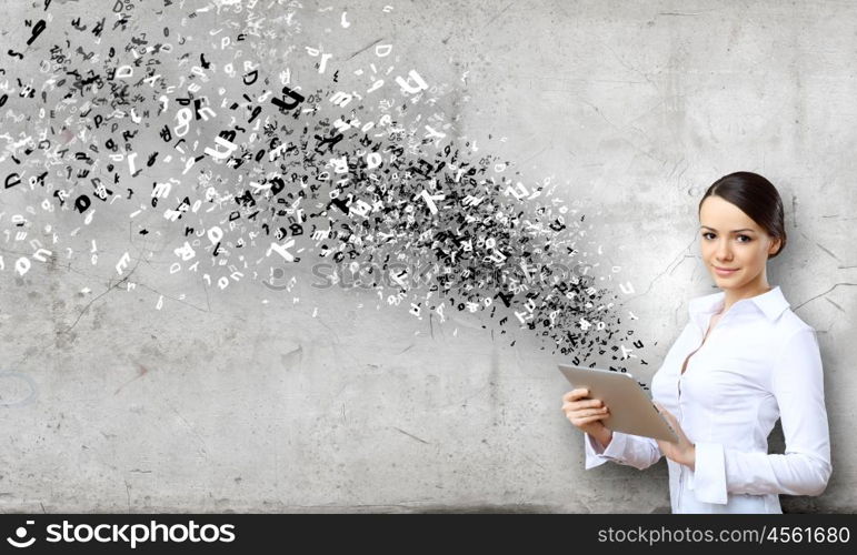 Woman with tablet. Young attractive woman in suit with tablet pc in hands