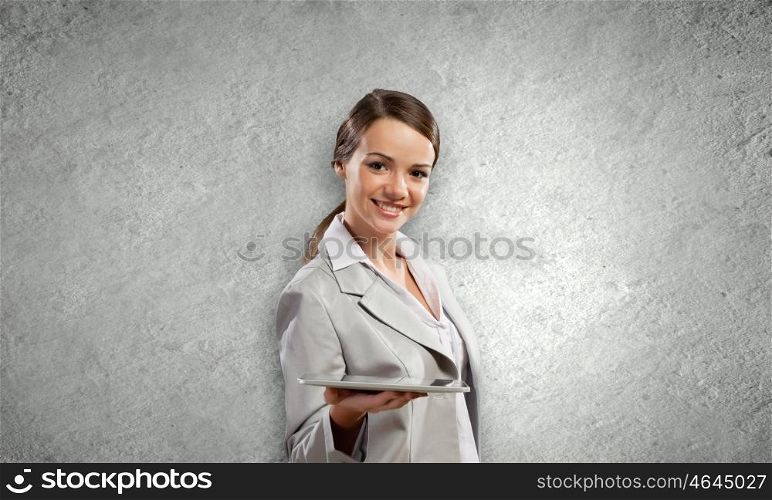 Woman with tablet. Young attractive woman in suit with tablet pc in hands