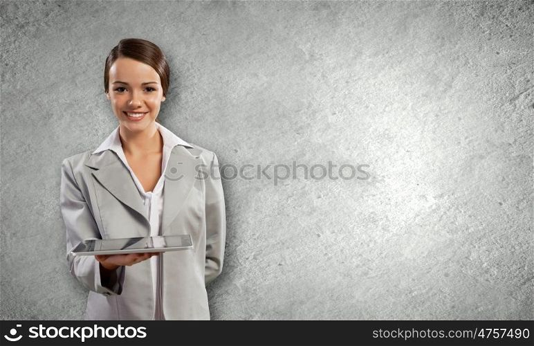Woman with tablet. Young attractive woman in suit with tablet pc in hands