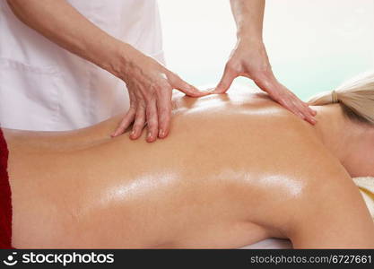 Woman with tattoo having back massage