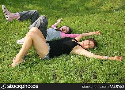 woman with teenager on the grass