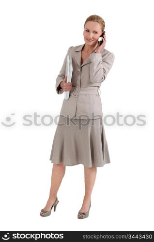 Woman with telephone and computer under the arm