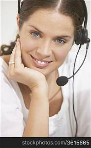 Woman with telephone headset smiling.
