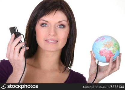Woman with telephone plugged into globe