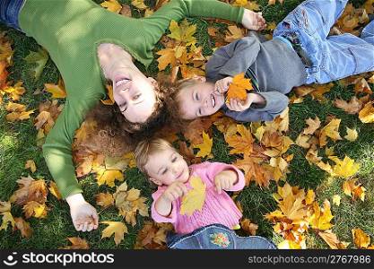 woman with the son and the daughter they lie on the grass 3