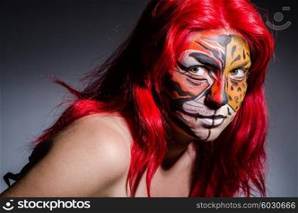 Woman with tiger face in halloween concept