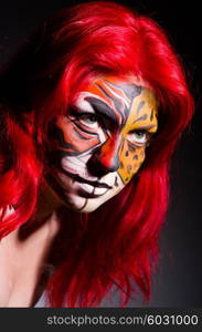 Woman with tiger face in halloween concept