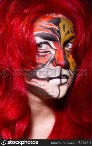 Woman with tiger face in halloween concept