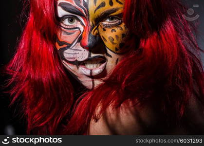 Woman with tiger face in halloween concept