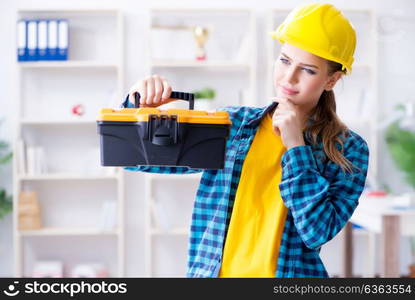 Woman with toolkit in workshop