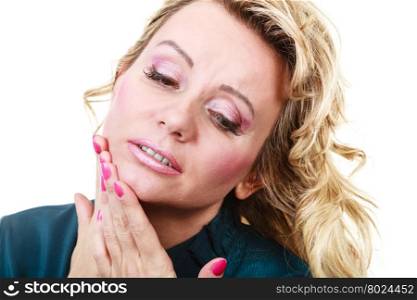 Woman with toothache problem. Aches and pains concept. Woman having bad ache and pain. Female feel tooth ache touching her mouth from outside by hand palm. Isolated on white.