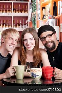 Woman with two male friends in a coffee house