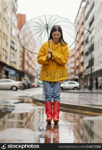 woman with umbrella standing rain long view