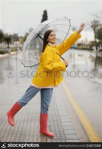 woman with umbrella standing rain side view 2