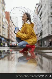 woman with umbrella standing rain side view