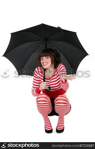 Woman with umbrella, studio shot