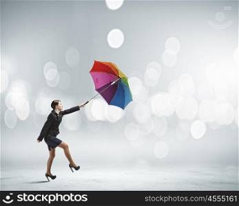 Woman with umbrella. Young businesswoman walking with colorful umbrella against bokeh background