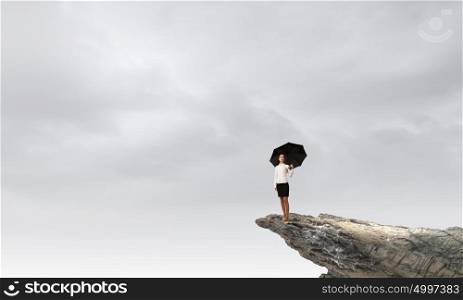 Woman with umbrella. Young businesswoman with black umbrella standing on top