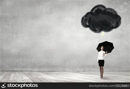 Woman with umbrella. Young businesswoman with black umbrella standing under black cloud
