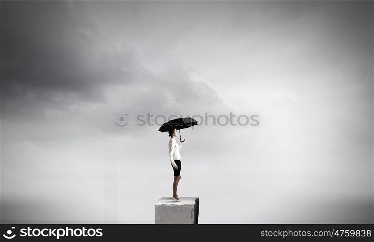 Woman with umbrella. Young pretty businesswoman in suit with black umbrella