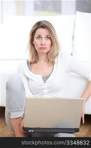 Woman with upset look using laptop computer