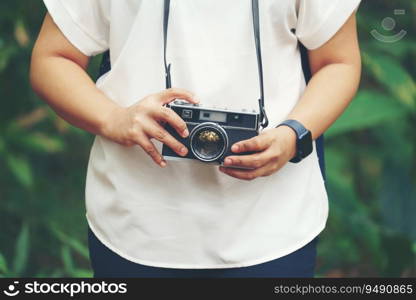 woman with vintage camera in park