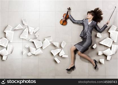 Woman with violin. Funny image of running businesswoman with violin in hand