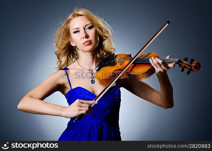 Woman with violin in studio