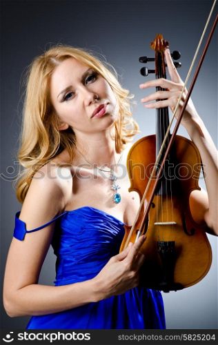 Woman with violin in studio