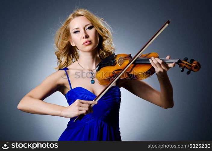 Woman with violin in studio