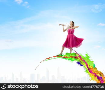 Woman with violin. Pretty lady in red dress playing violin