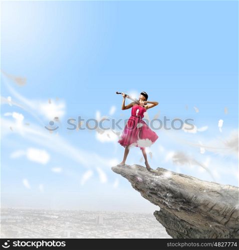 Woman with violin. Pretty lady in red dress playing violin