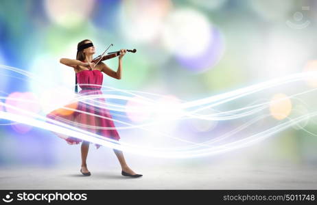 Woman with violin. Pretty lady in red dress playing violin