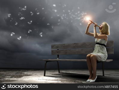 Woman with violin. Young woman sitting on bench and playing fife