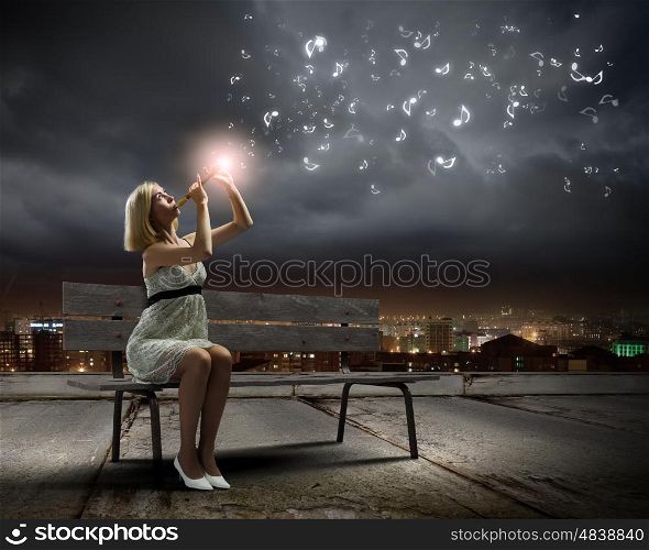 Woman with violin. Young woman sitting on bench and playing fife