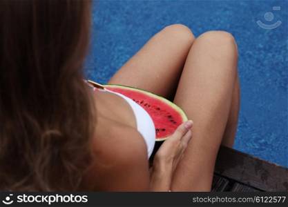 Woman with watermelon. Woman with watermelon by the pool
