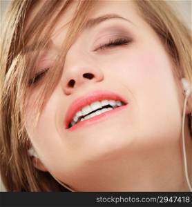 Woman with white headphones listening to music and singing a song. Student girl learning language with new technology.