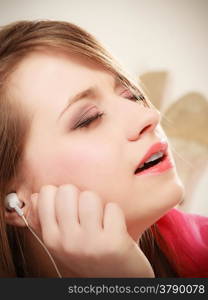 Woman with white headphones listening to music and singing a song. Student girl learning language with new technology.